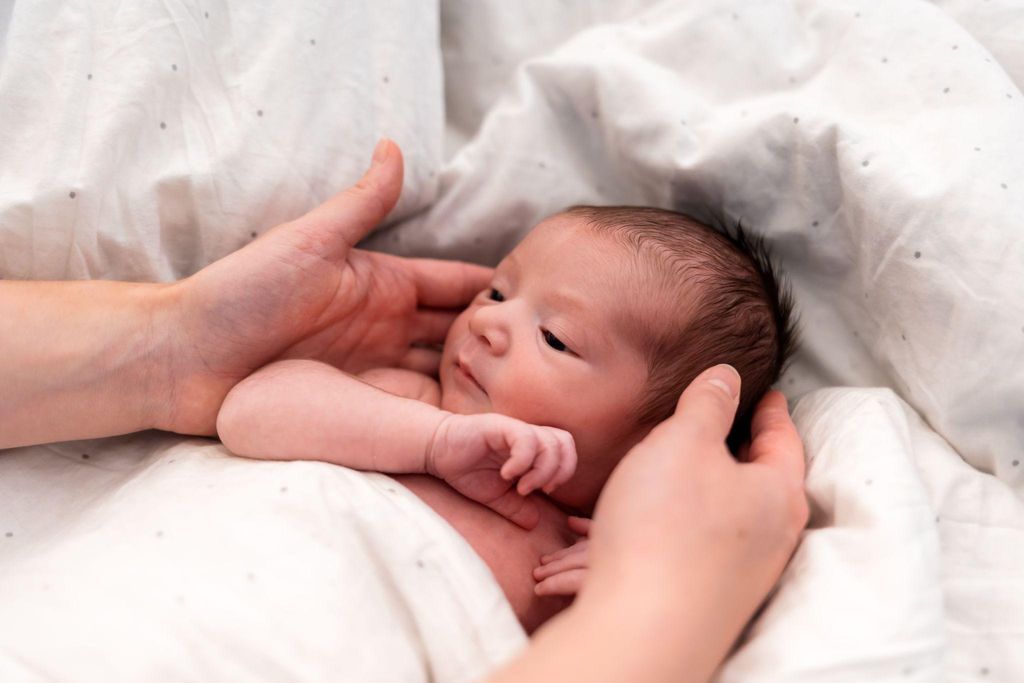 Newborn baby with a naturally rounded head shape, shortly after birth.