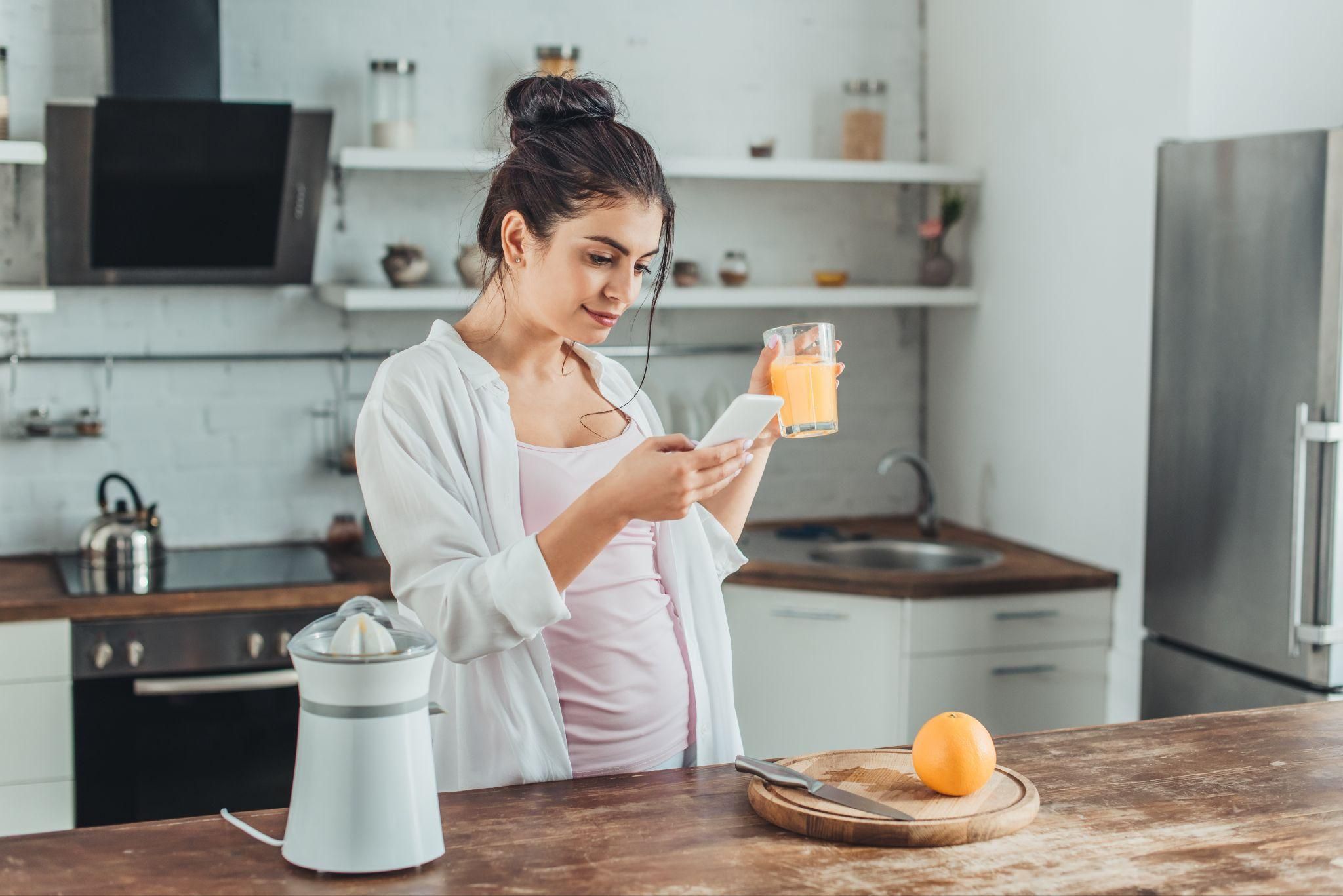 A serene image of a pregnant woman journaling to reflect the strength and resilience of pregnancy influencers.