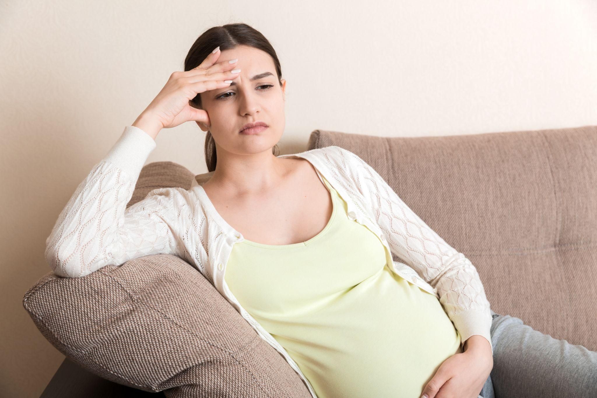 A pregnant couple participating in an antenatal class, learning about baby care and parenting.