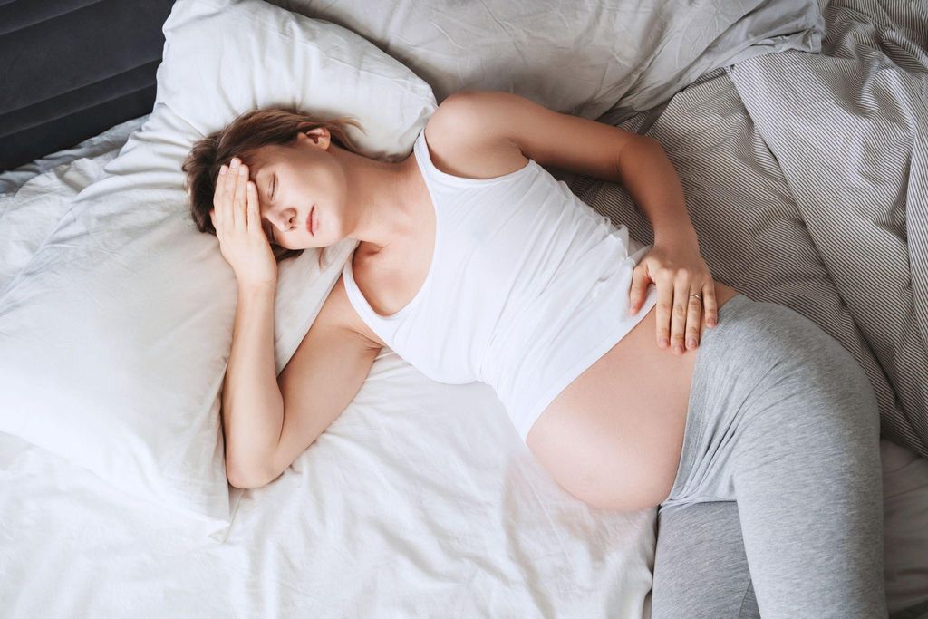 A pregnant woman struggling with inadequate sleep during pregnancy.