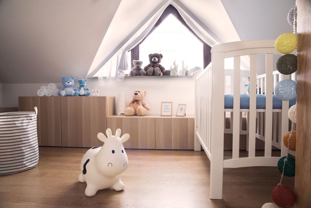 A cosy and stylish nursery with soft lighting, storage solutions, and baby essentials.