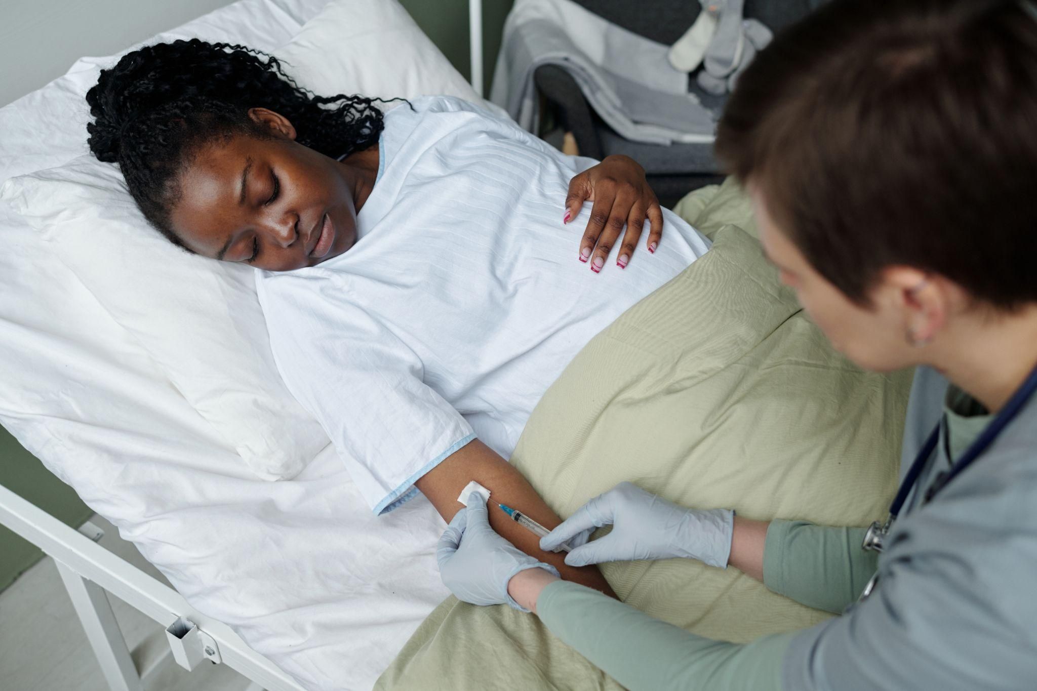 A doctor providing antenatal care to a pregnant woman