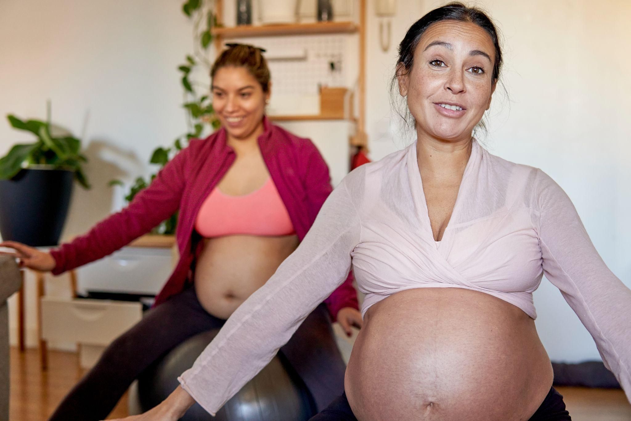 Expectant parents learning relaxation techniques during an antenatal education session.