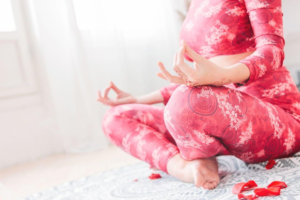 A pregnant woman attending an antenatal yoga class to prepare for labour.