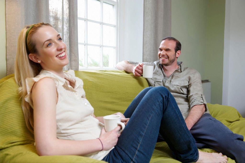 A couple discussing pregnancy hormones before an antenatal appointment.