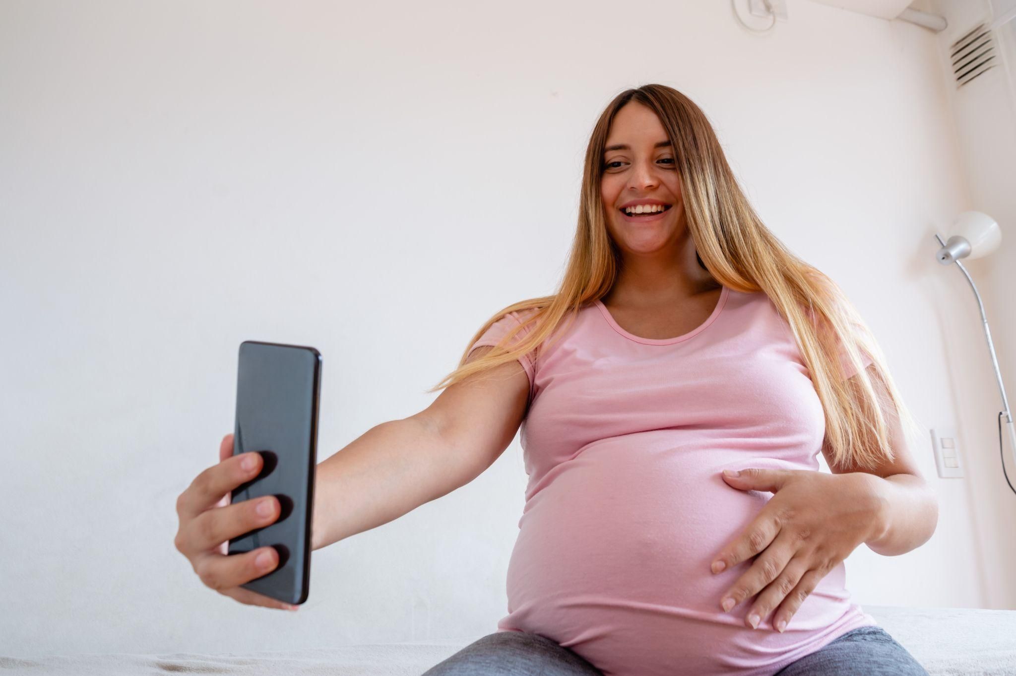 Pregnant woman browsing social media for baby care tips.