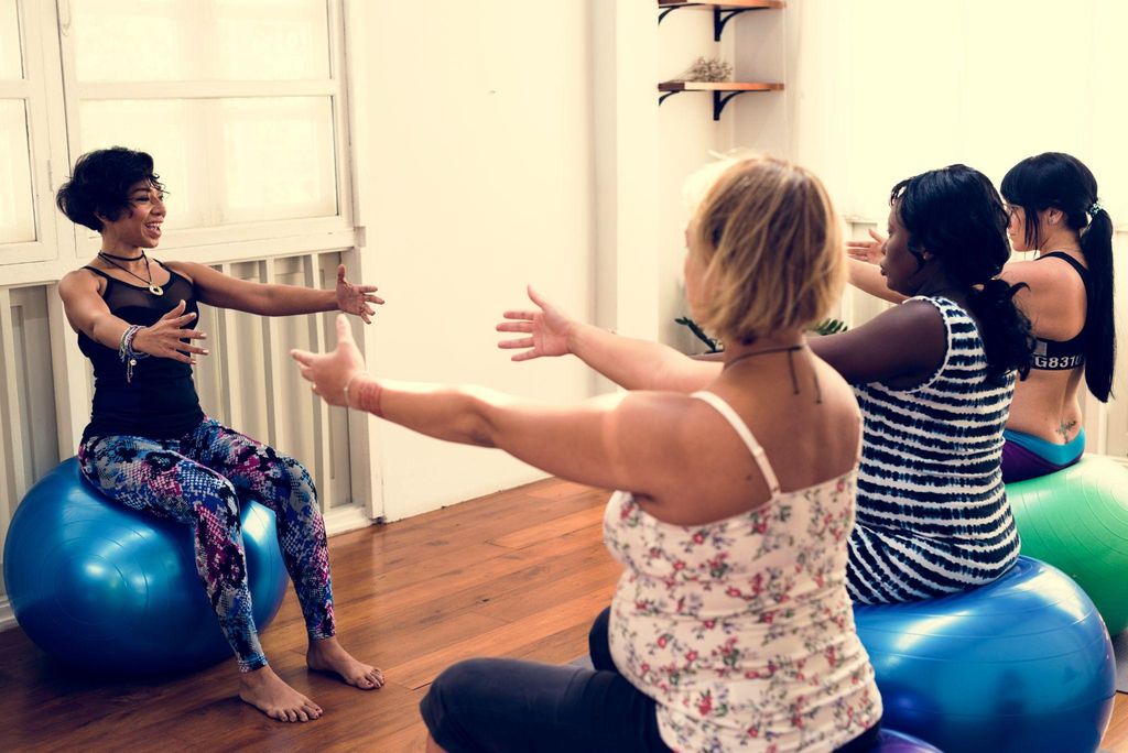 A pregnant woman practising antenatal yoga in a serene studio setting.