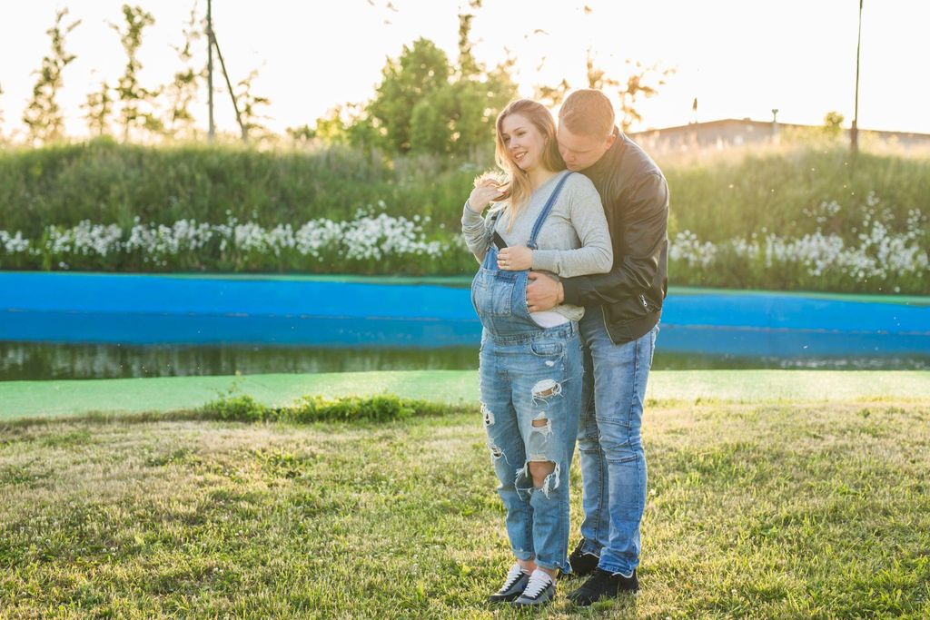 Pregnant woman gently cradling her belly, feeling reassured about the safety of her baby.