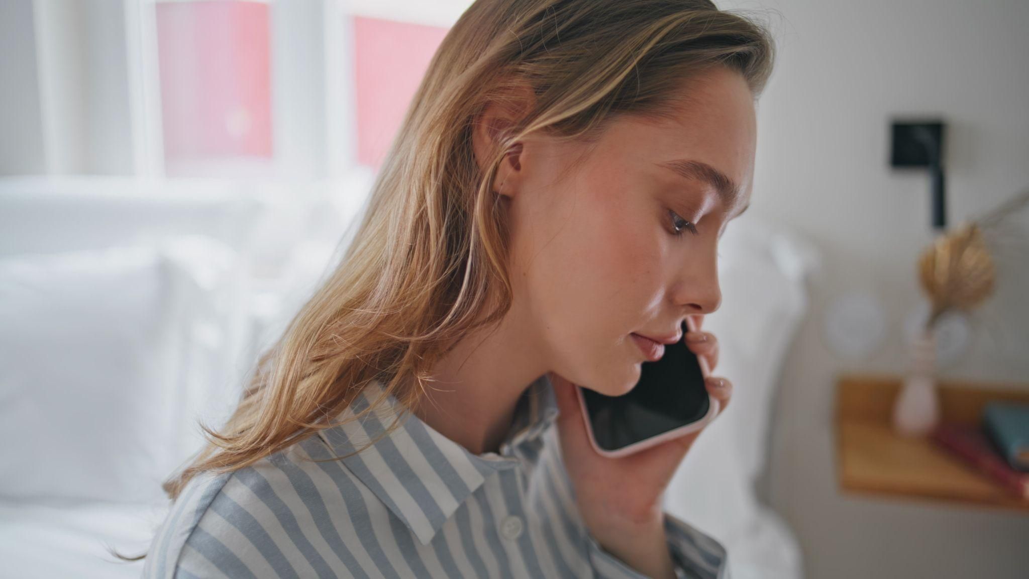 Pregnant woman on phone to hospital.