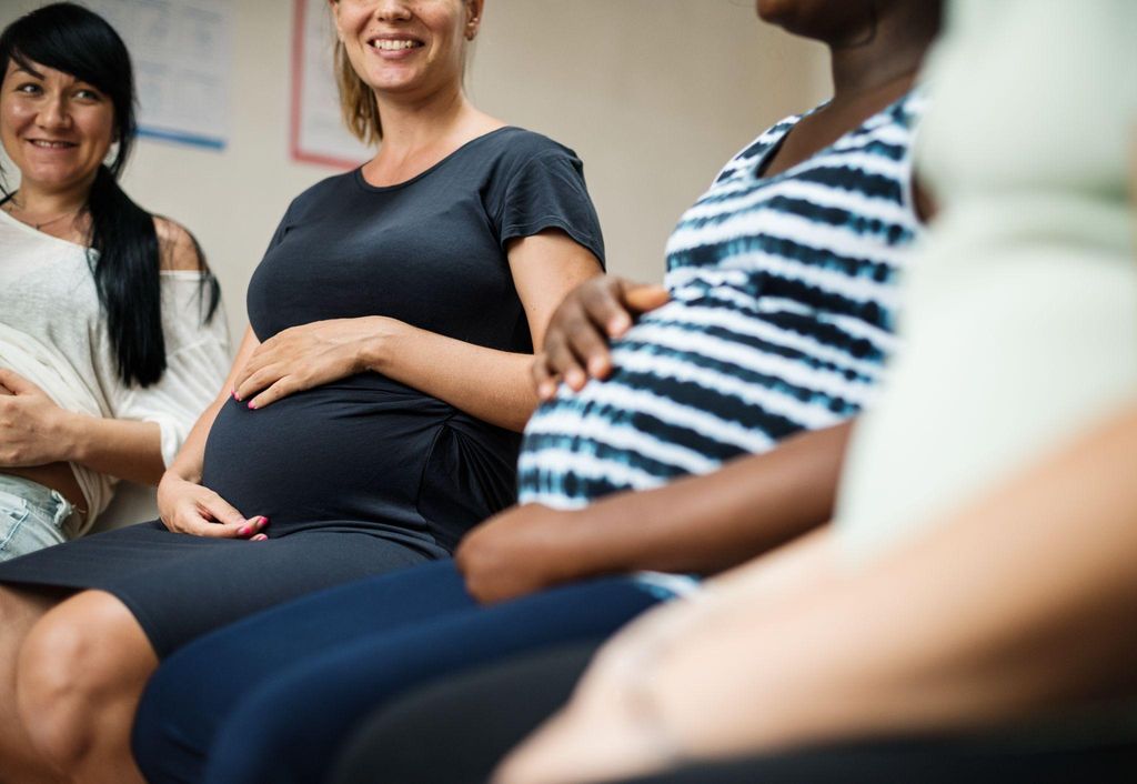 A pregnant woman practising hypnobirthing techniques with her partner during a class in London.