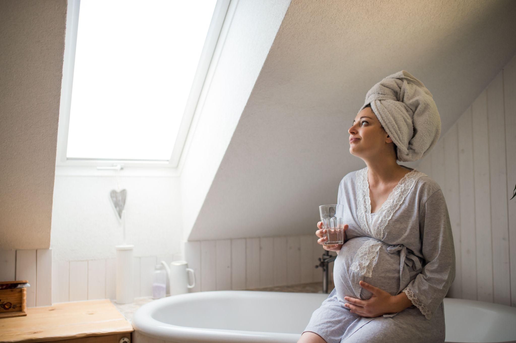 A calm water birth setting with a birthing pool and supportive lighting.