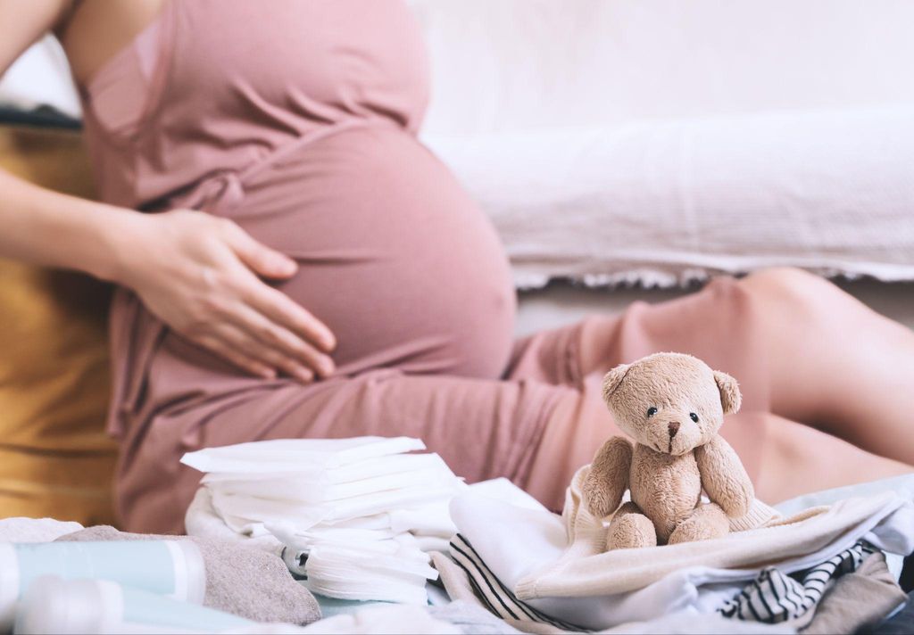 An organised hospital bag packed with clothes, baby items, and toiletries for childbirth.