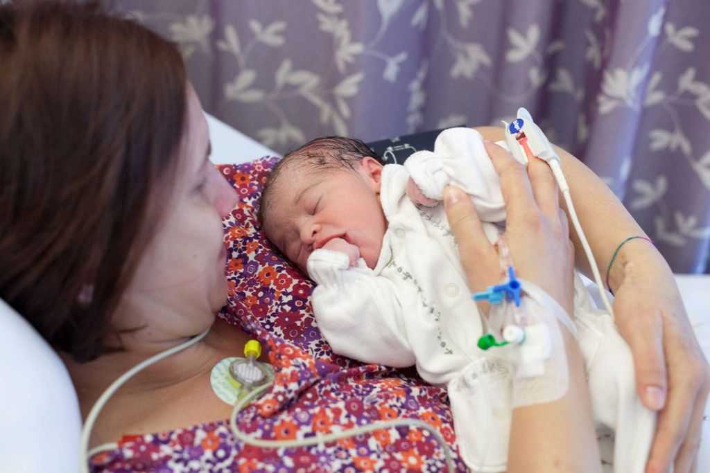 Woman with newborn on chest.