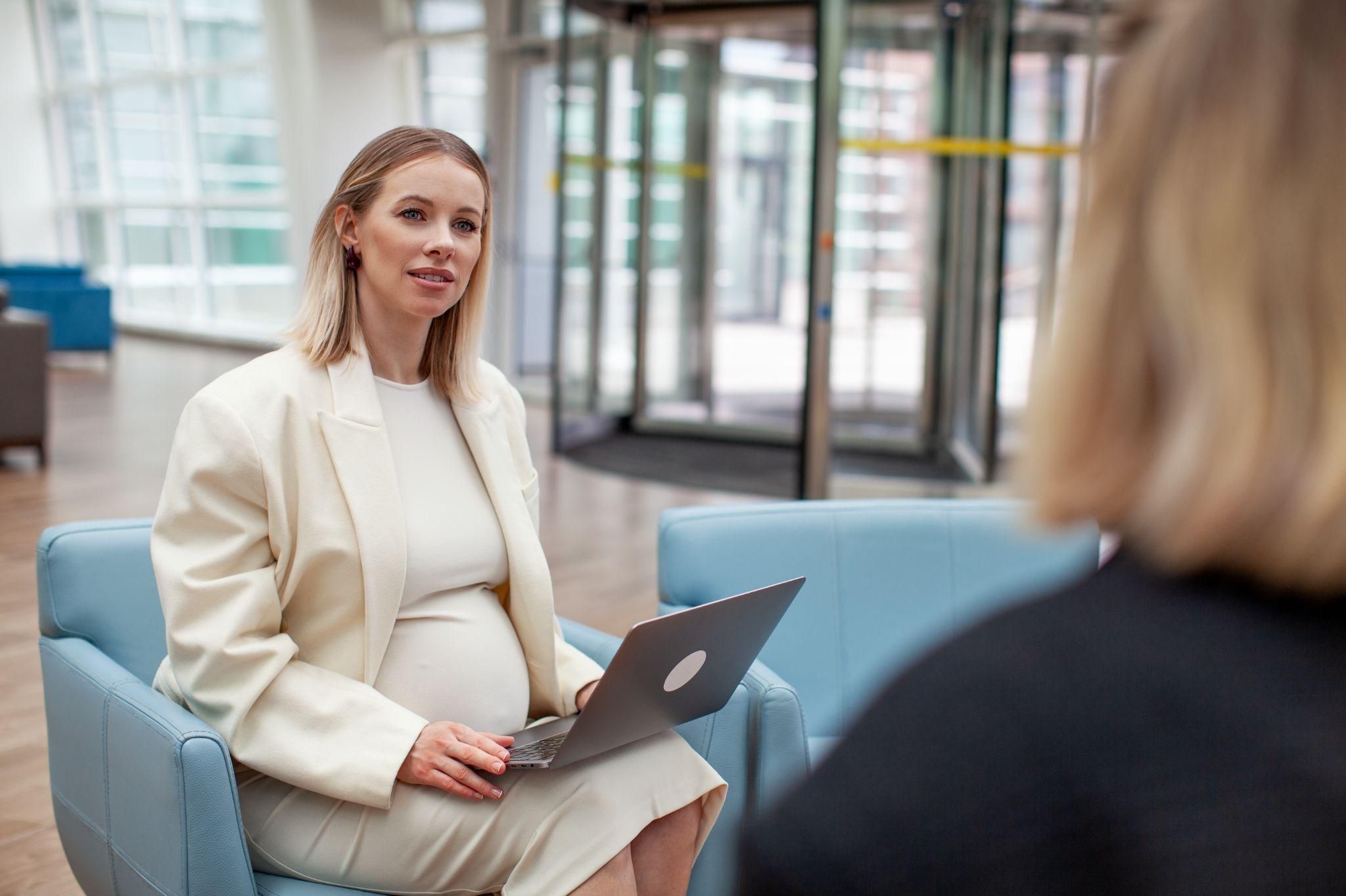 Pregnant woman balancing work and antenatal appointments.