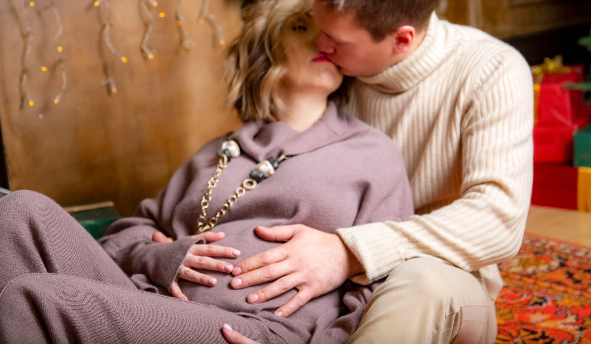 A pregnant couple connecting emotionally and physically during pregnancy.