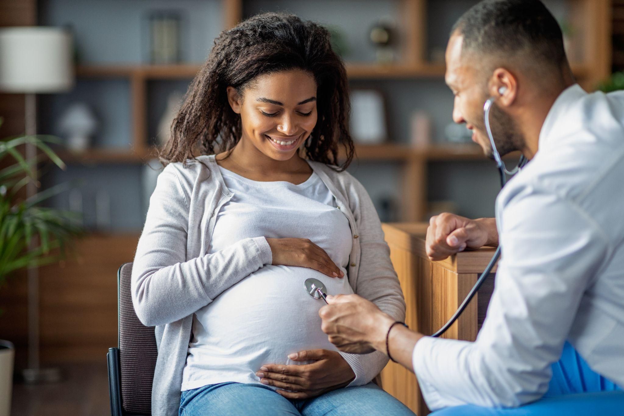 A happy pregnant woman enjoying antenatal care at a clinic.