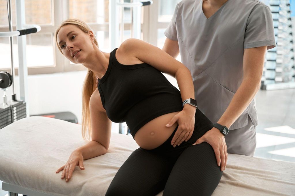 A pregnant woman having a physiotherapy massage to maintain good posture.