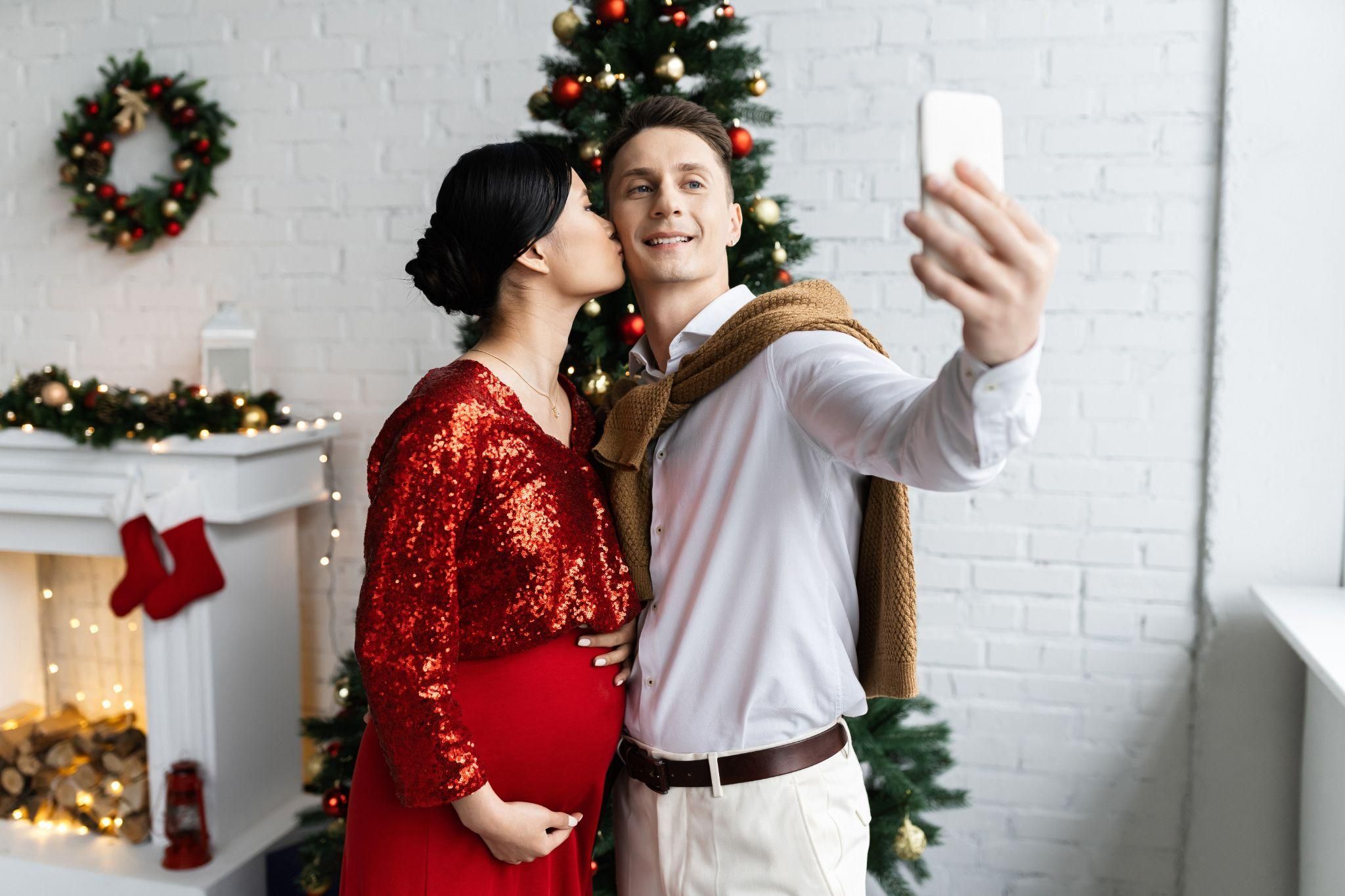 Pregnant couple take Christmas selfie