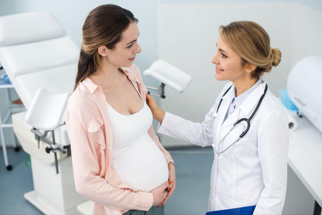 A healthcare provider discussing antenatal growth factors with a pregnant woman.