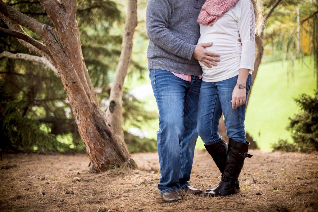 Happy pregnant couple in nature.