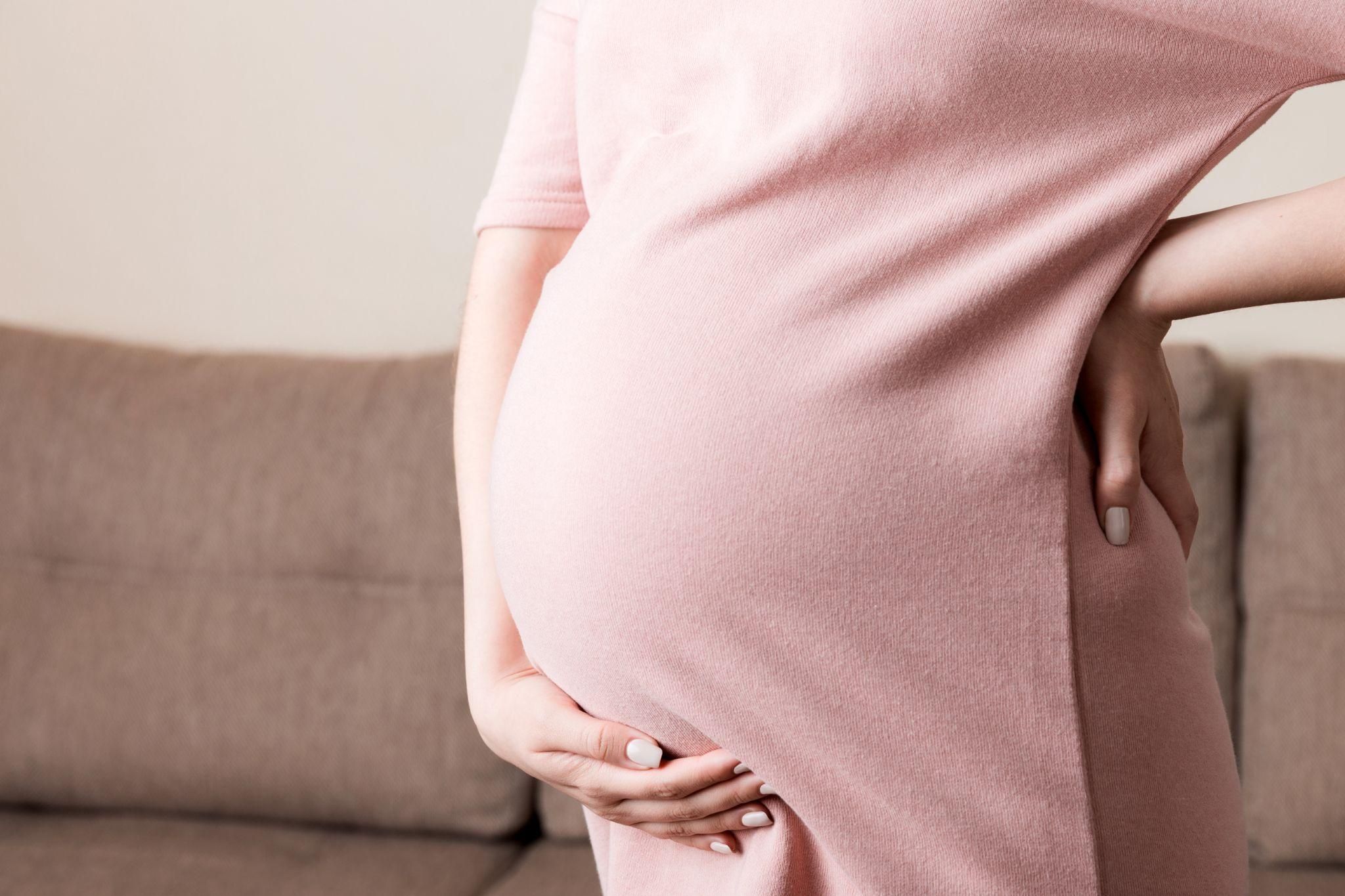 Pregnant woman at 34 weeks practicing antenatal yoga.