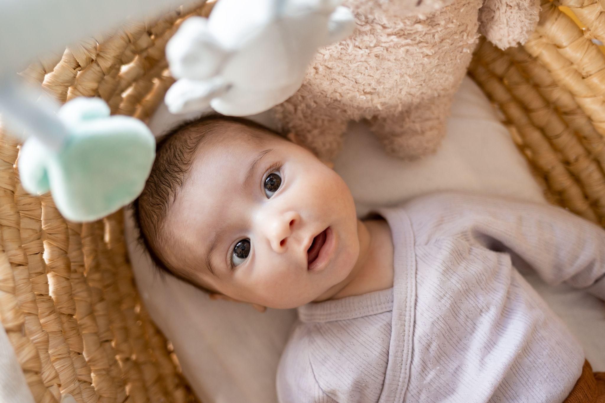 Organic baby clothes displayed alongside baby toys, showcasing sustainable and hypoallergenic options.