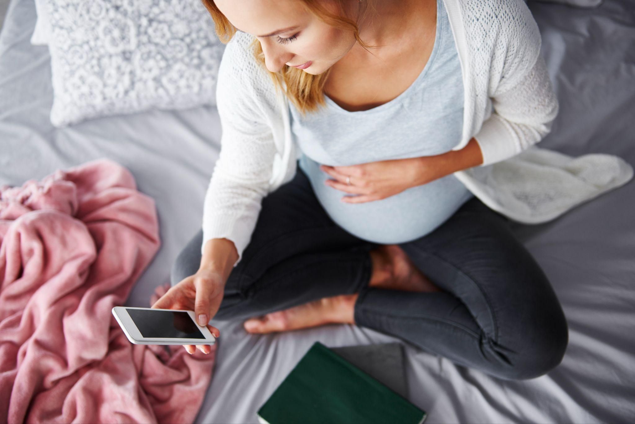 A pregnant woman navigating antenatal self-referral online in the UK.