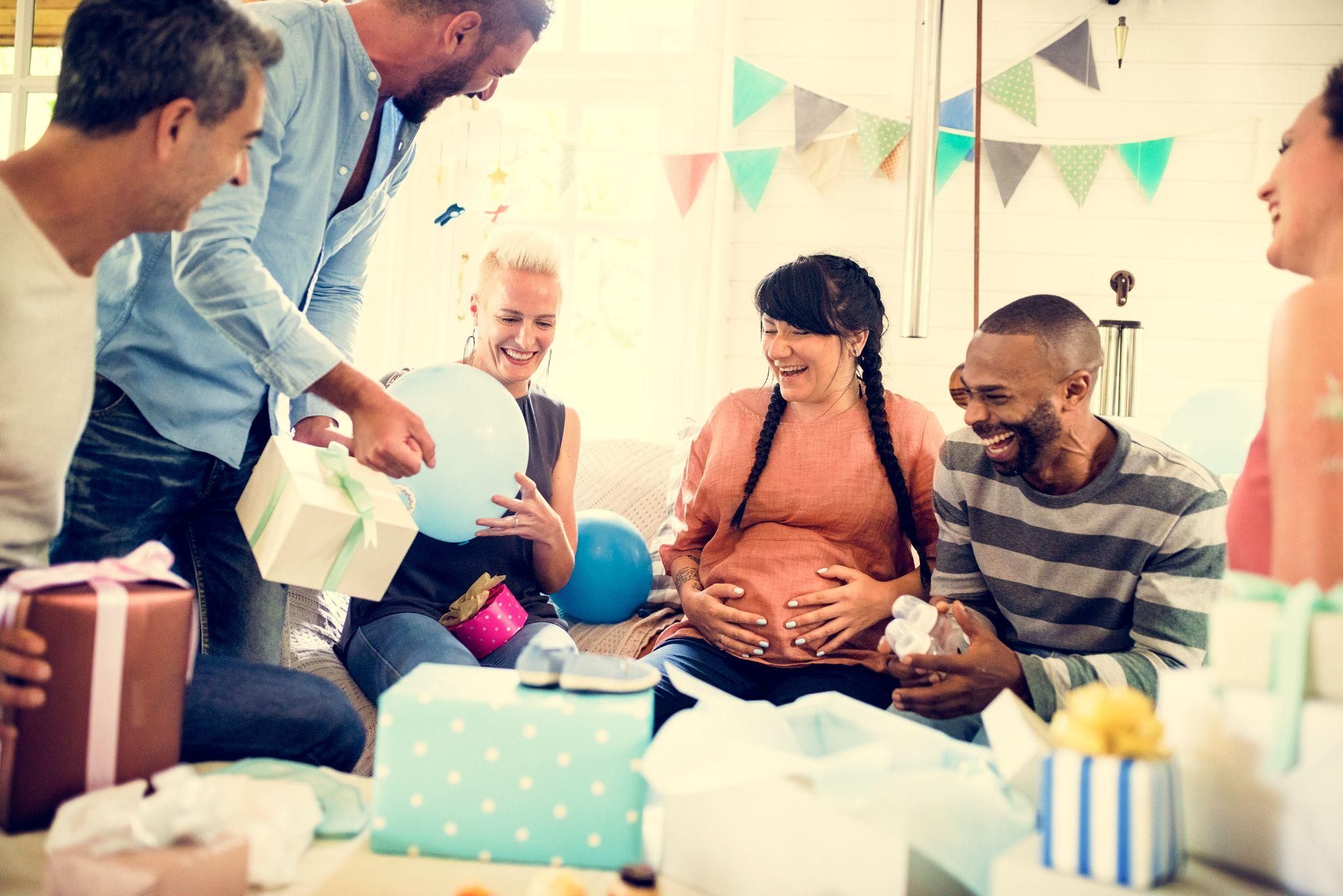 A group of friends enjoying the “Guess the Baby Food” game during a baby shower.