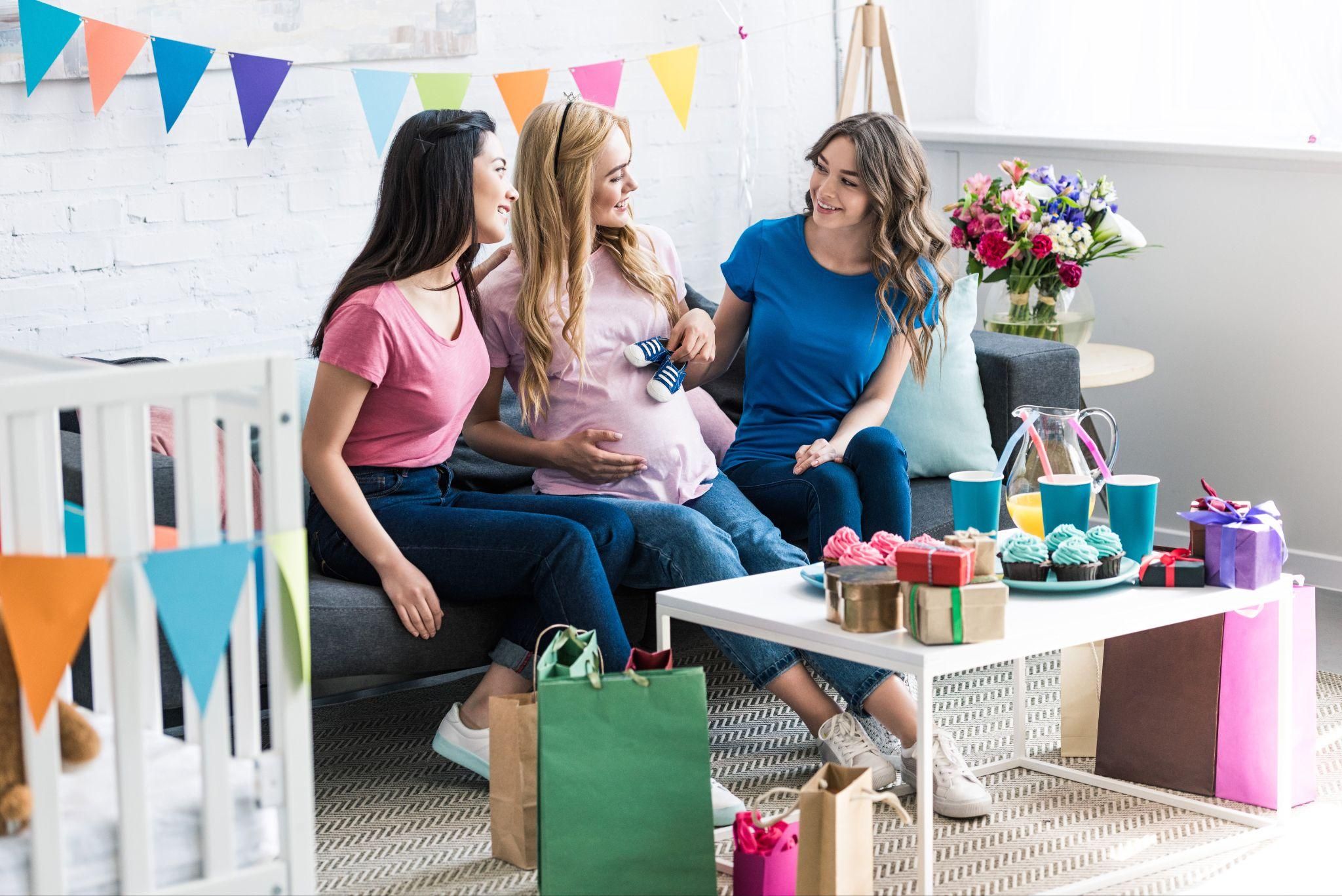 Baby shower gifts like keepsakes, baby blankets, and skincare products displayed in a nursery.