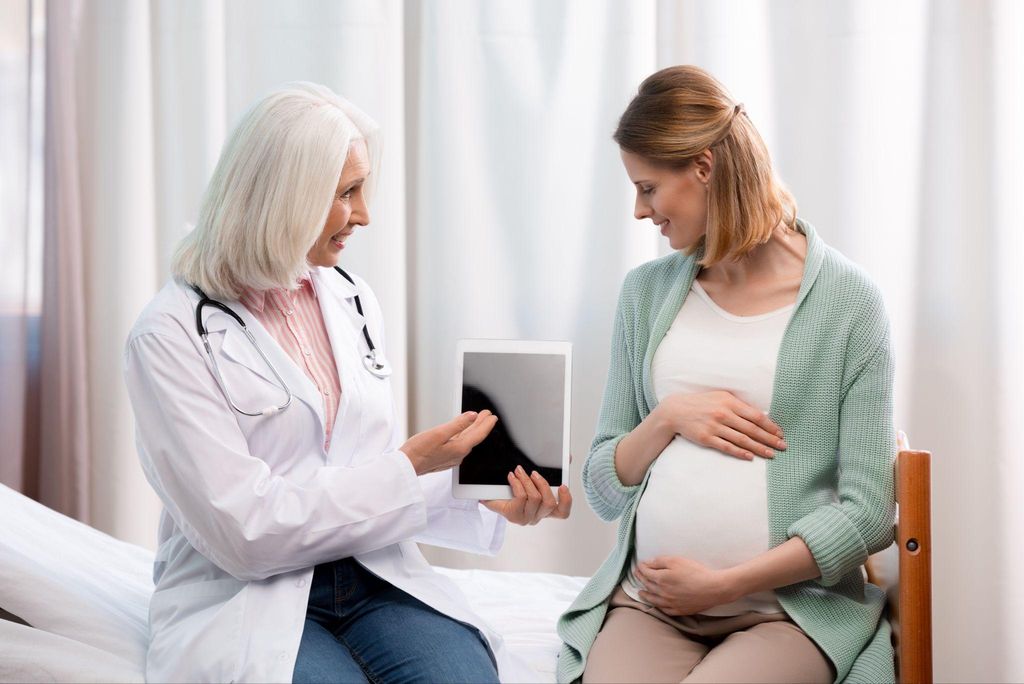 Pregnant woman receiving antenatal care from a healthcare professional.