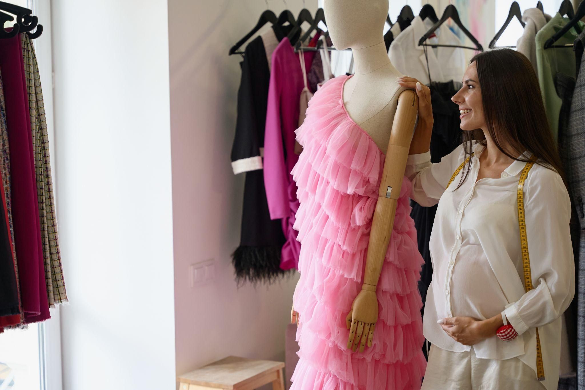 Pregnant woman in stylish maternity clothes, ready for work.