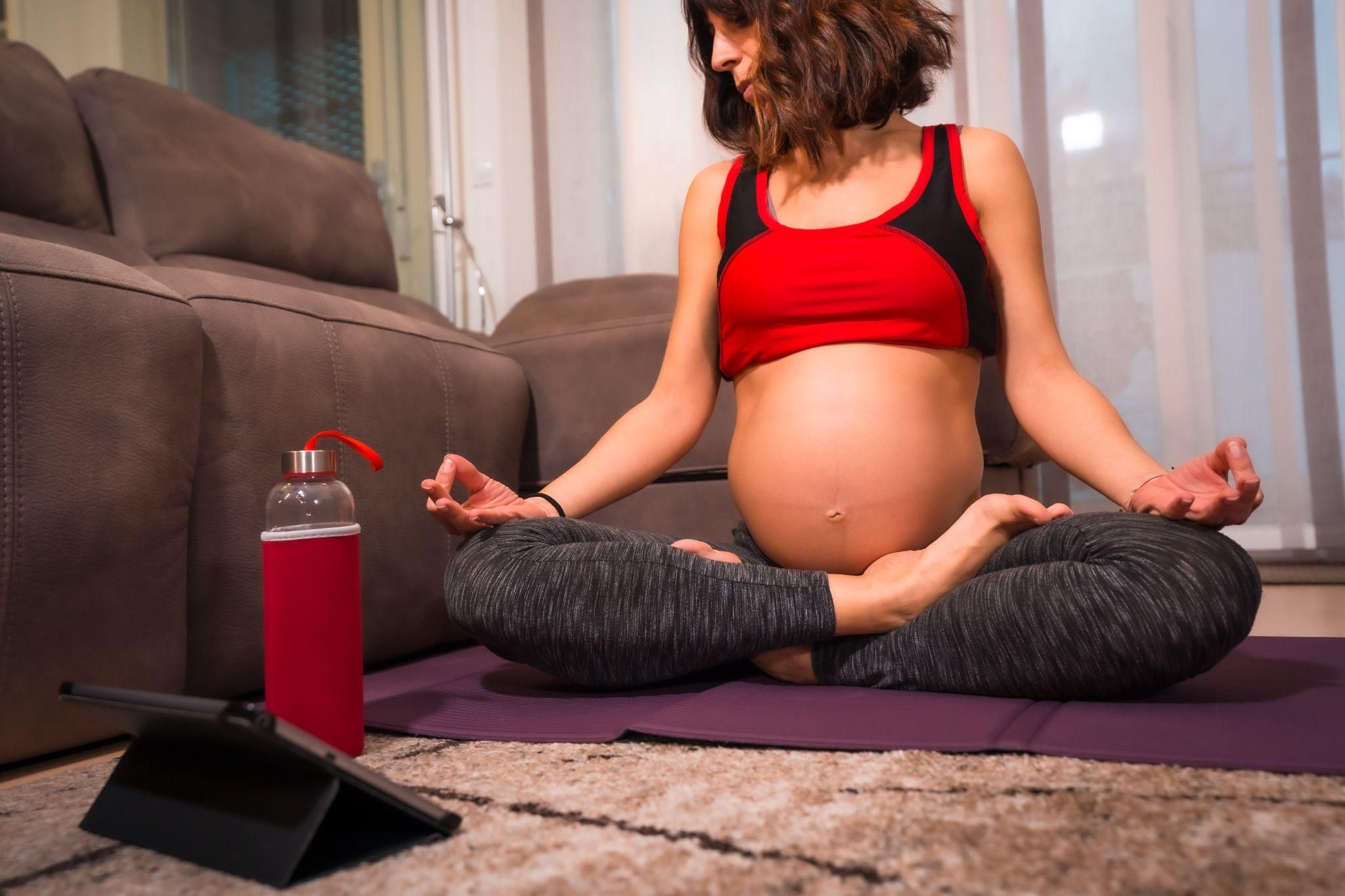 Expectant mum practising hypnobirthing techniques with deep breathing and relaxation.