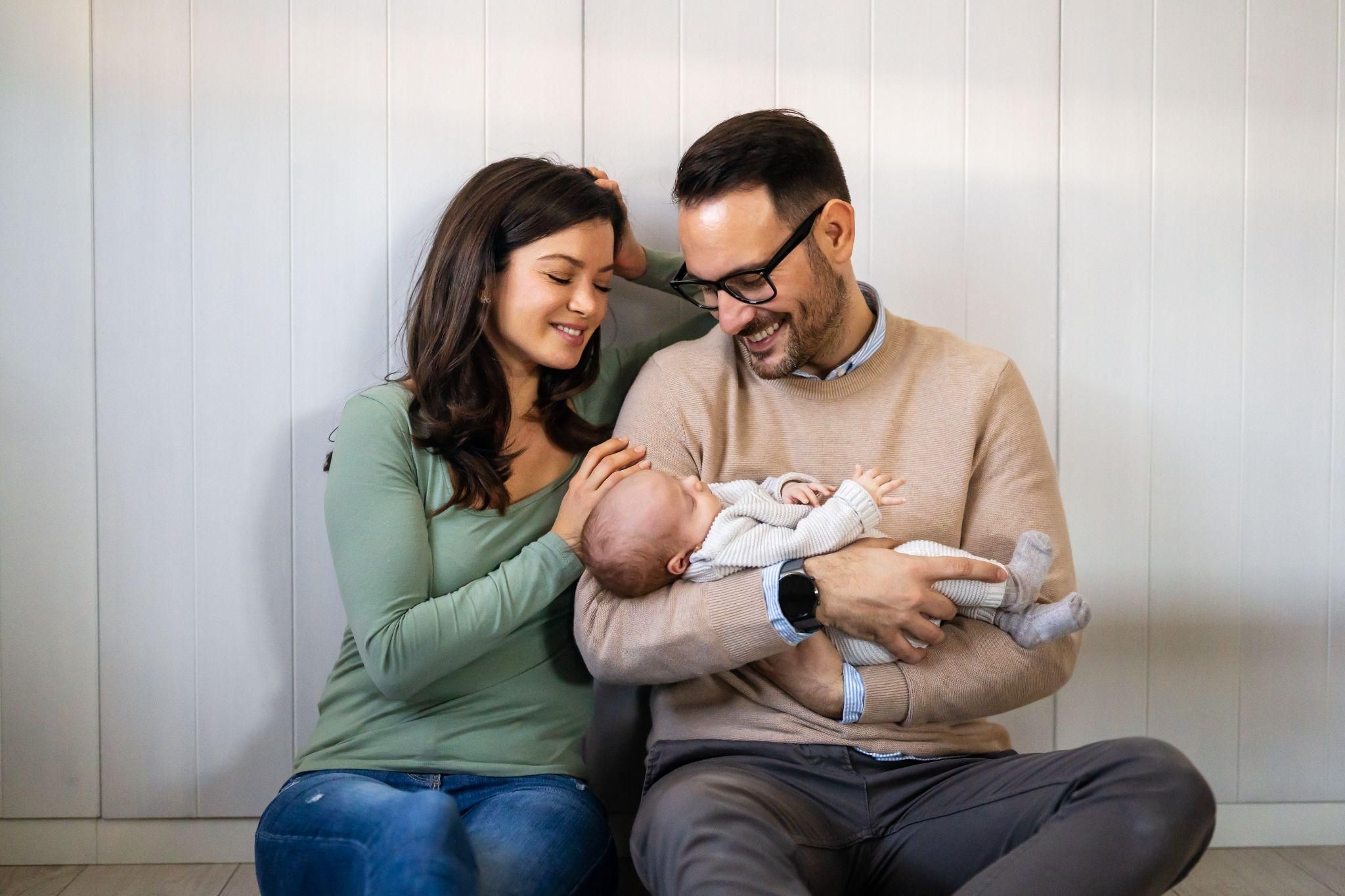 A new mother feeling confident and calm while holding her baby, symbolising progress over perfection.