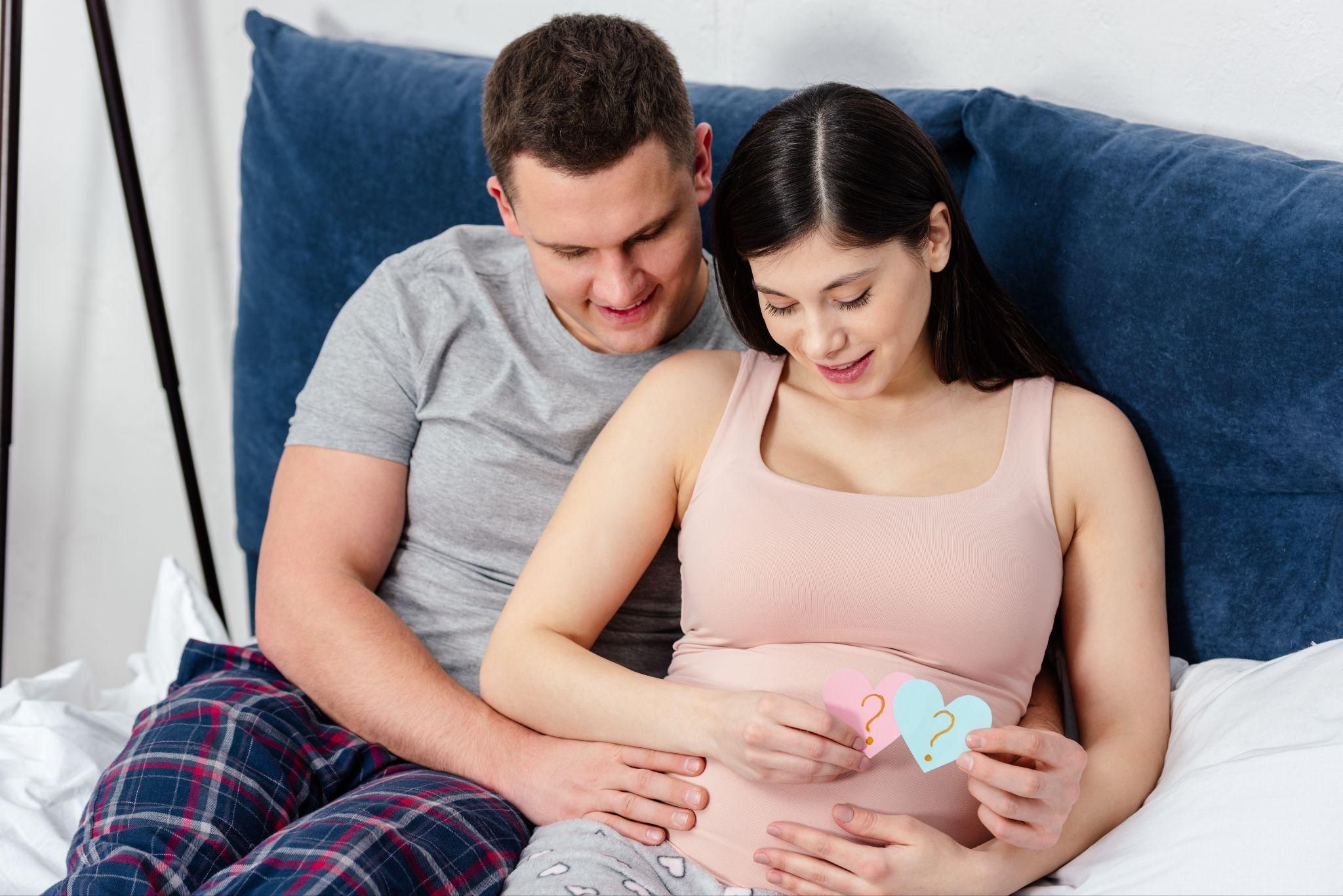 An expectant dad reviewing a pregnancy checklist alongside his partner.