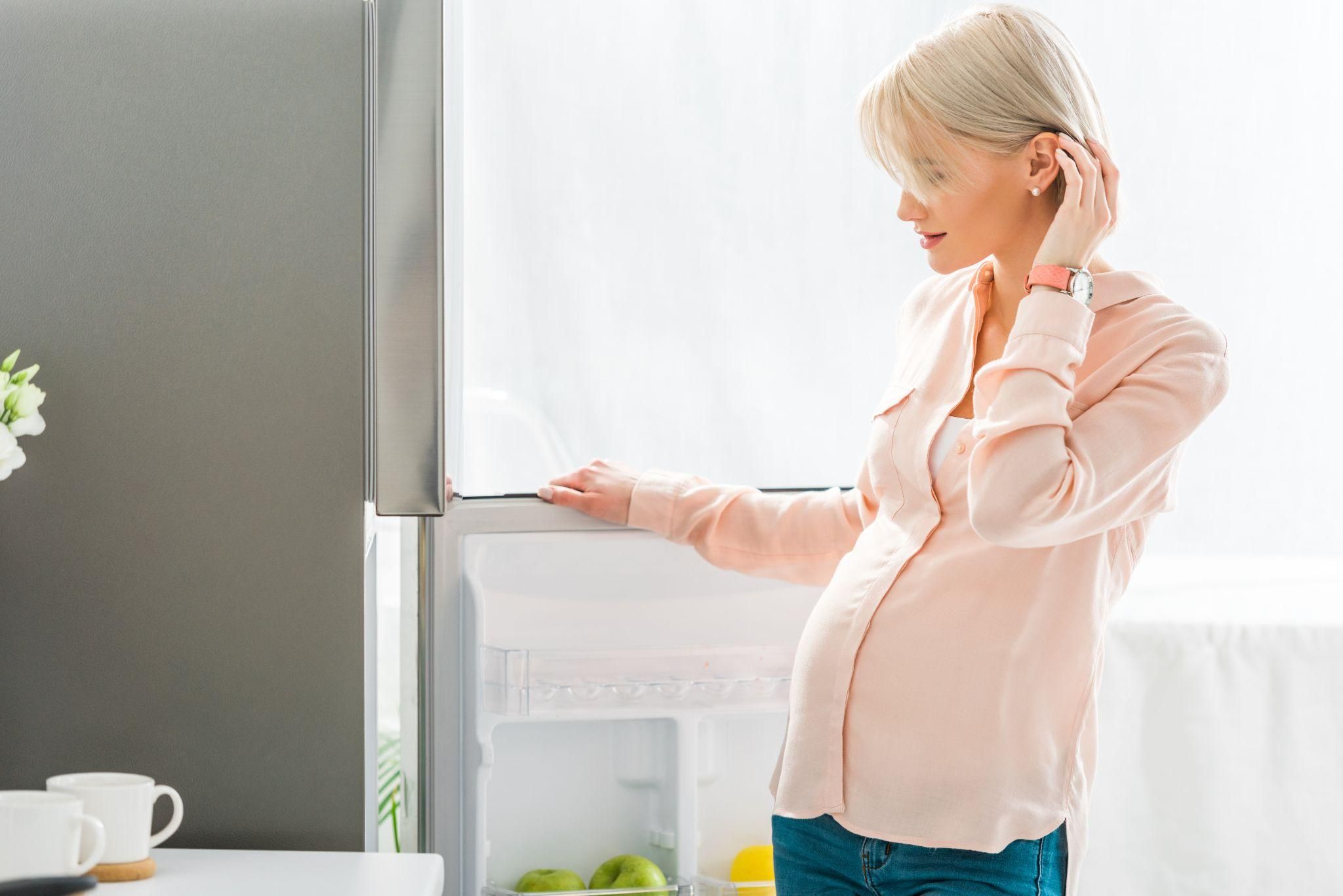 Pregnant woman selecting healthy processed snacks for antenatal nutrition.