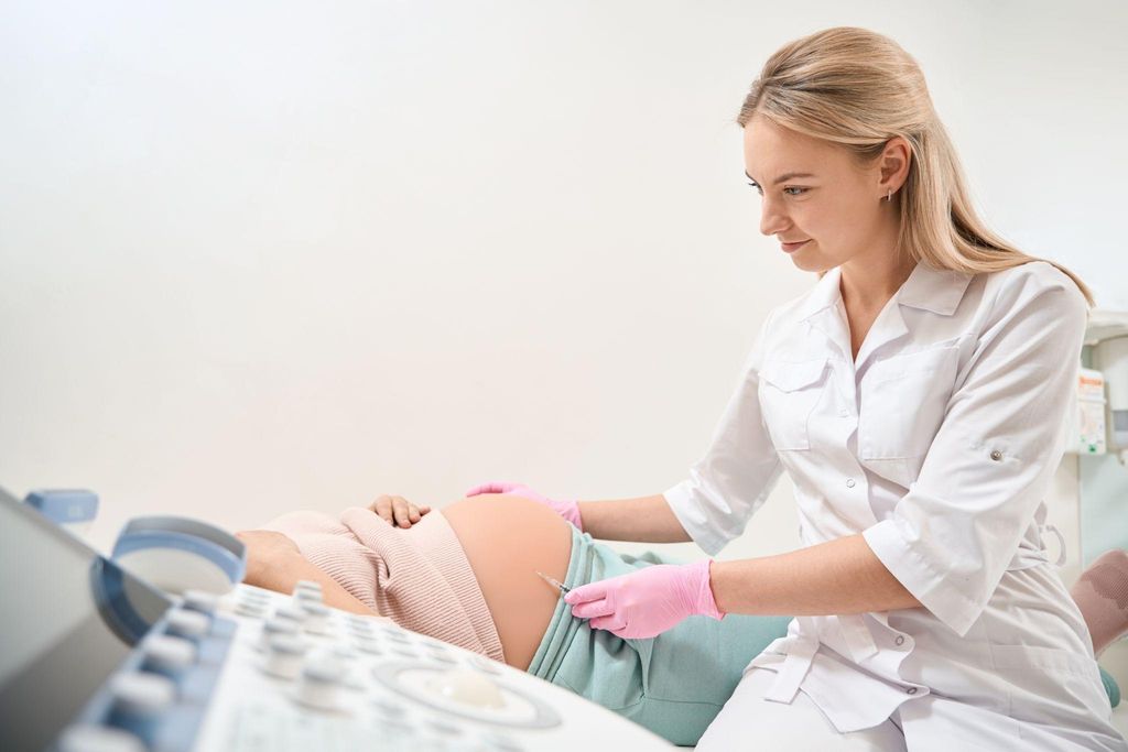 A healthcare professional administering antenatal steroids to a pregnant woman at risk of preterm birth.