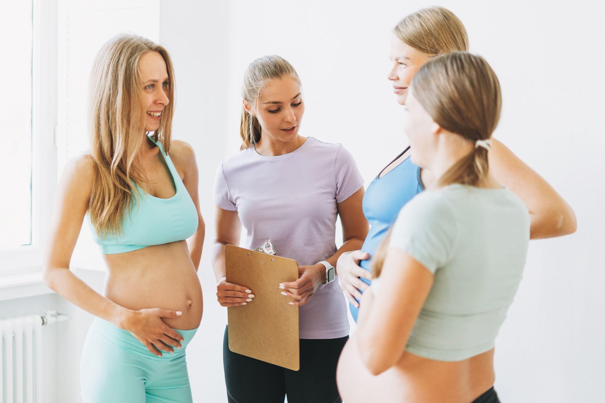 Pregnant women chat with instructor at antenatal course.