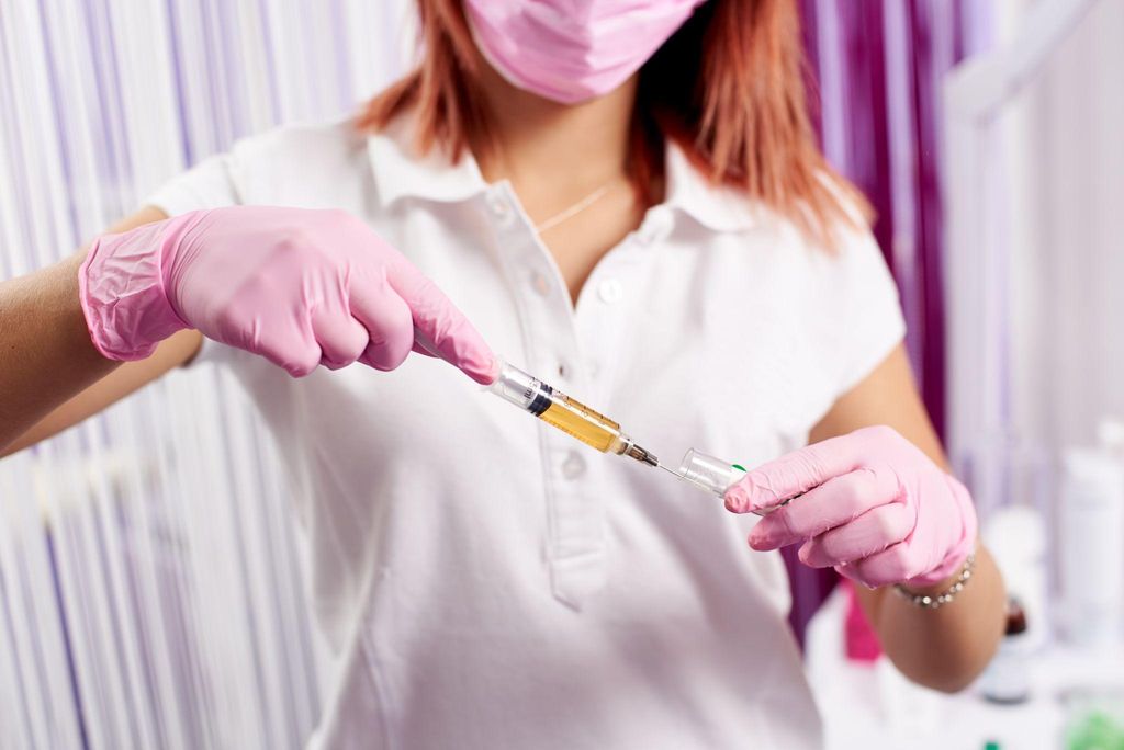 A pregnant woman receiving a vaccination during an antenatal appointment.