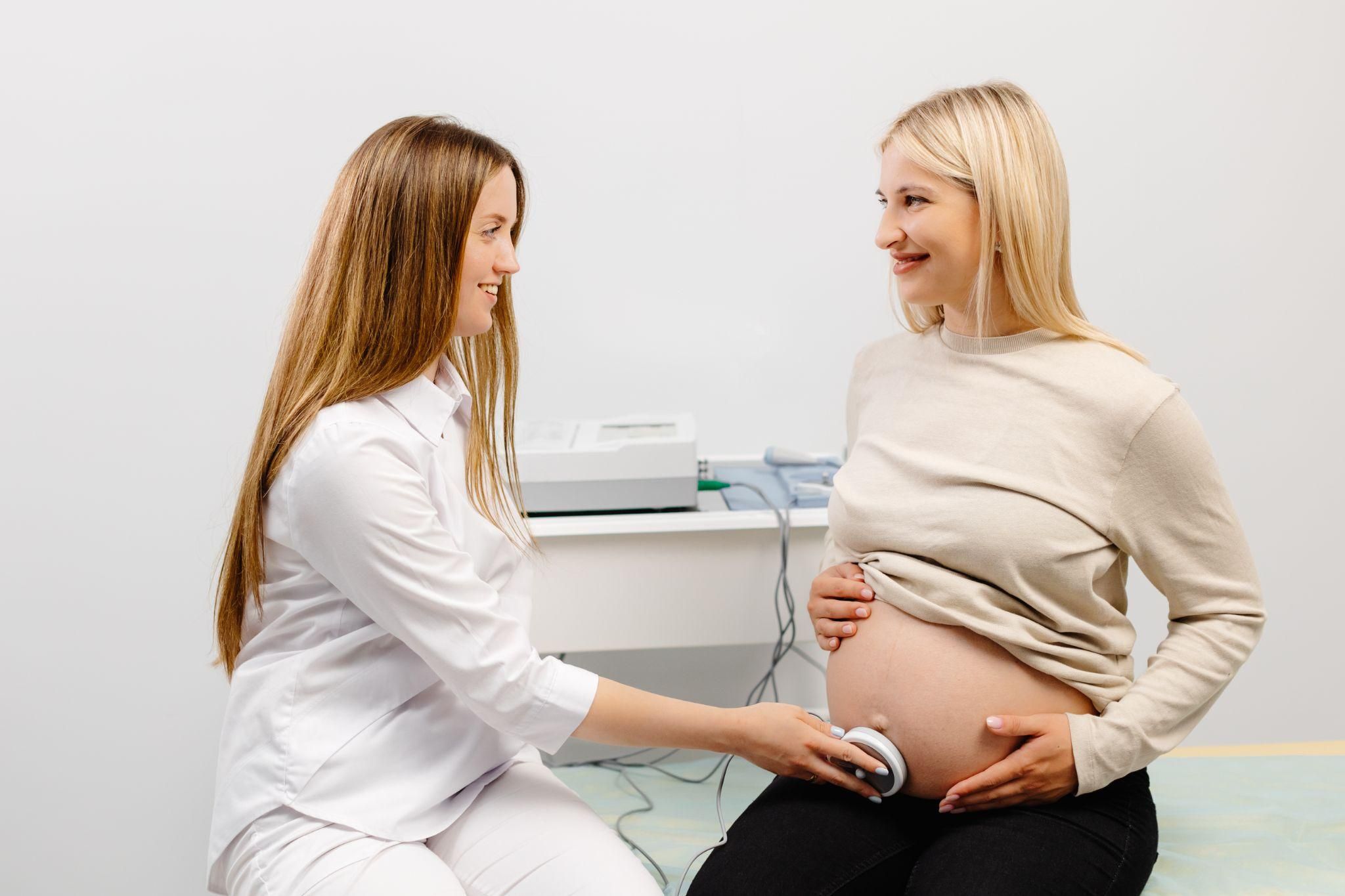 Pregnant woman having a fetal heartbeat check during an antenatal appointment.