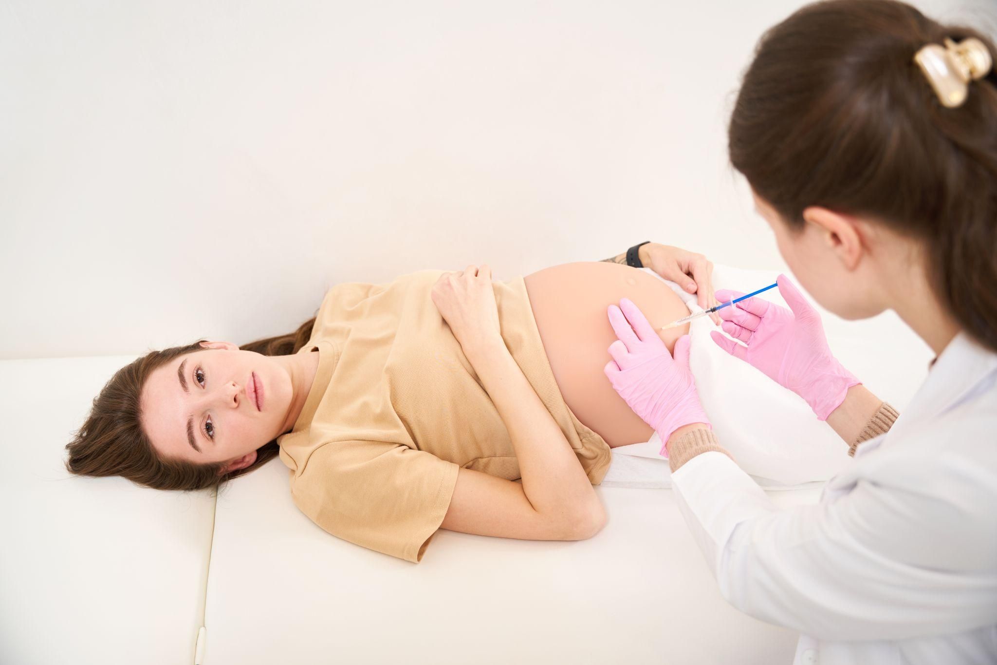 A pregnant woman receiving guidance during an antenatal appointment.