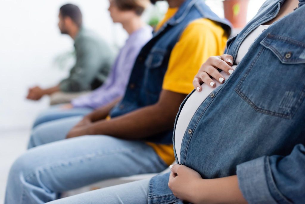 A London antenatal clinic with expectant mothers waiting for their appointments.