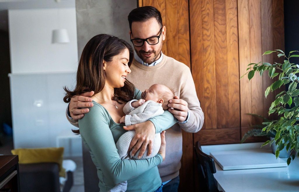 A new mother holding her baby, navigating the emotional rollercoaster of the postpartum period with love and joy.