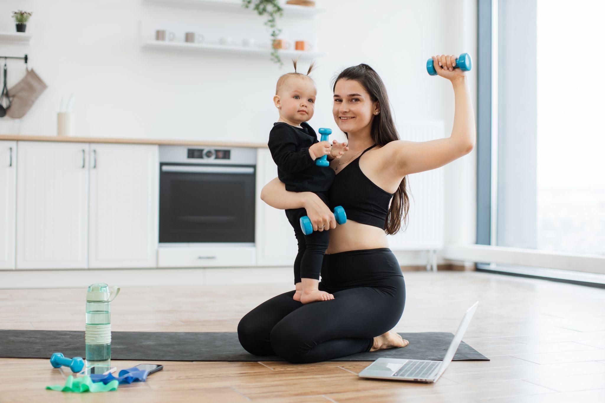 A new mother practising postnatal yoga to regain strength and focus on mental well-being after childbirth.