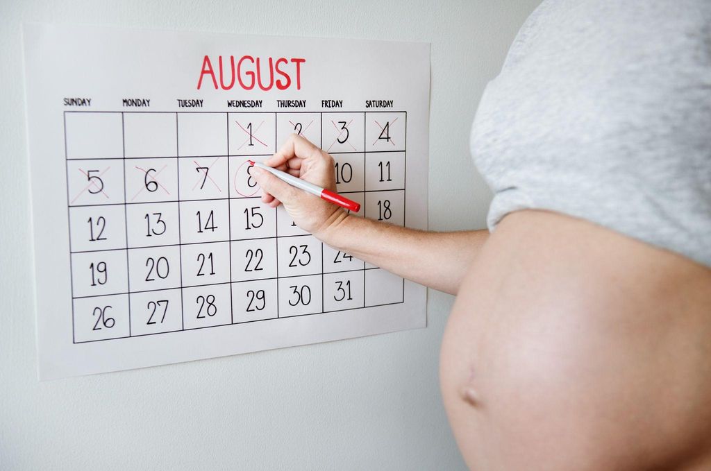 A woman nearing her due date, contemplating when her baby will arrive