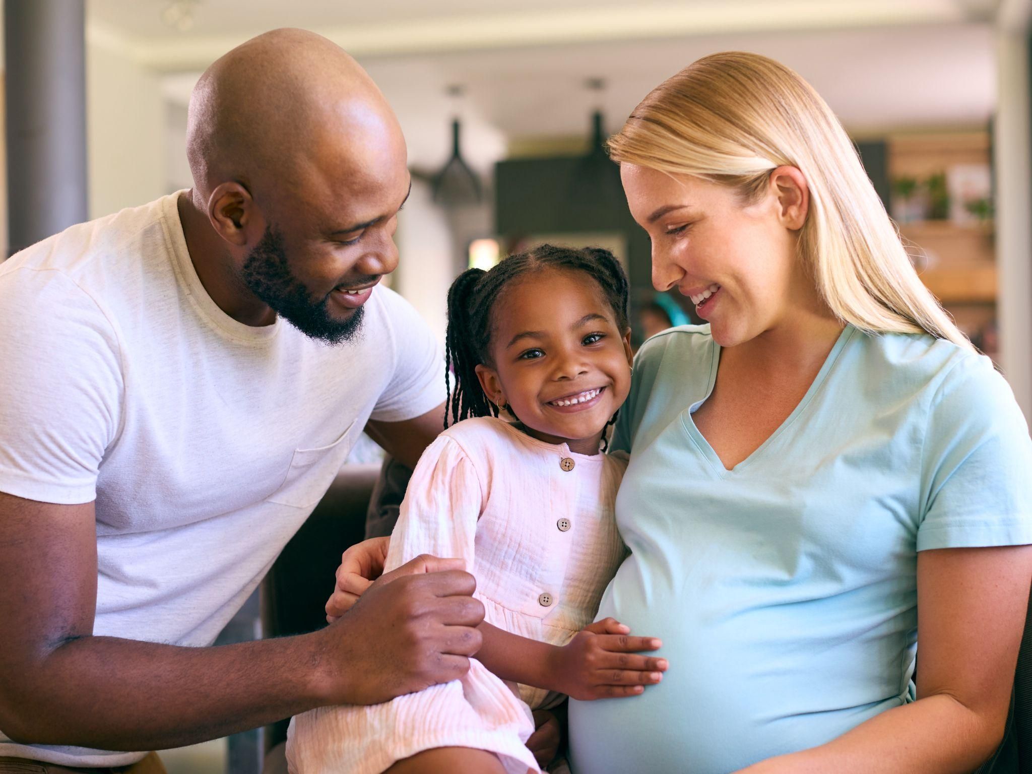 Partner supporting a pregnant woman.