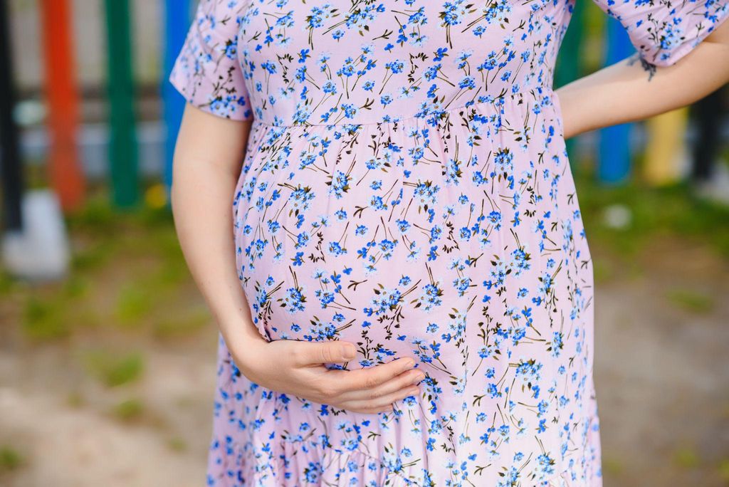 A mother recovering from a C-section, wearing soft, comfortable clothing that supports her healing process.