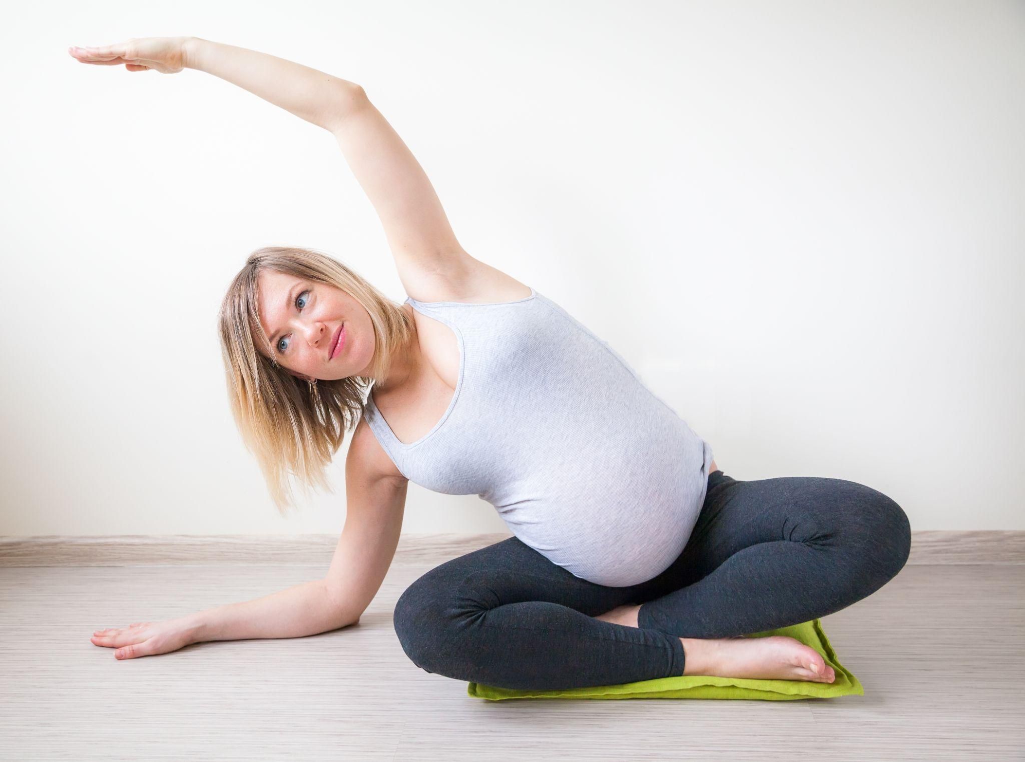 A mother in labour supported by her partner in an upright birthing position.