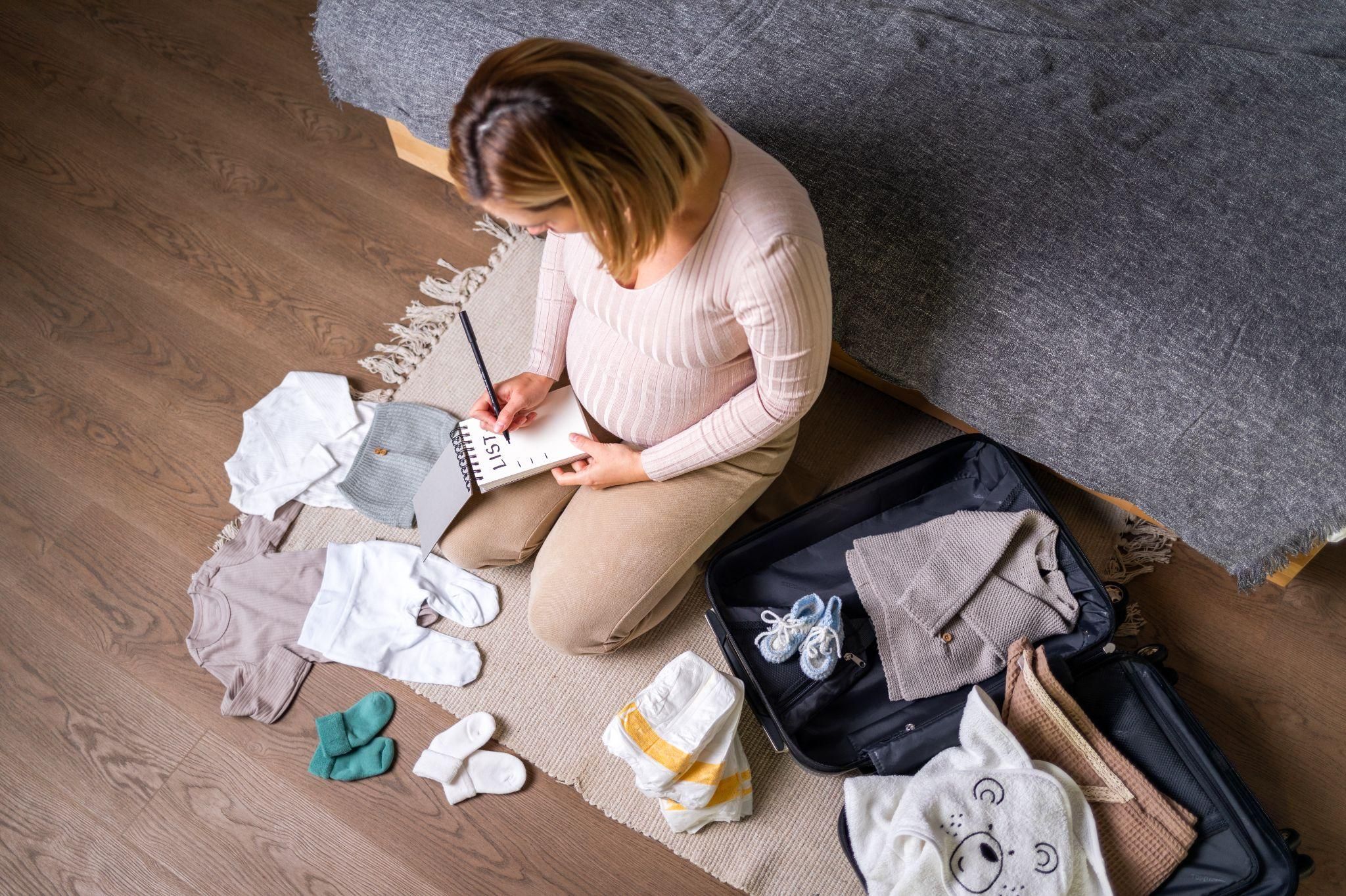 A postpartum survival kit with essential items for new mothers, including maternity pads, nursing bras, and pain relief products.