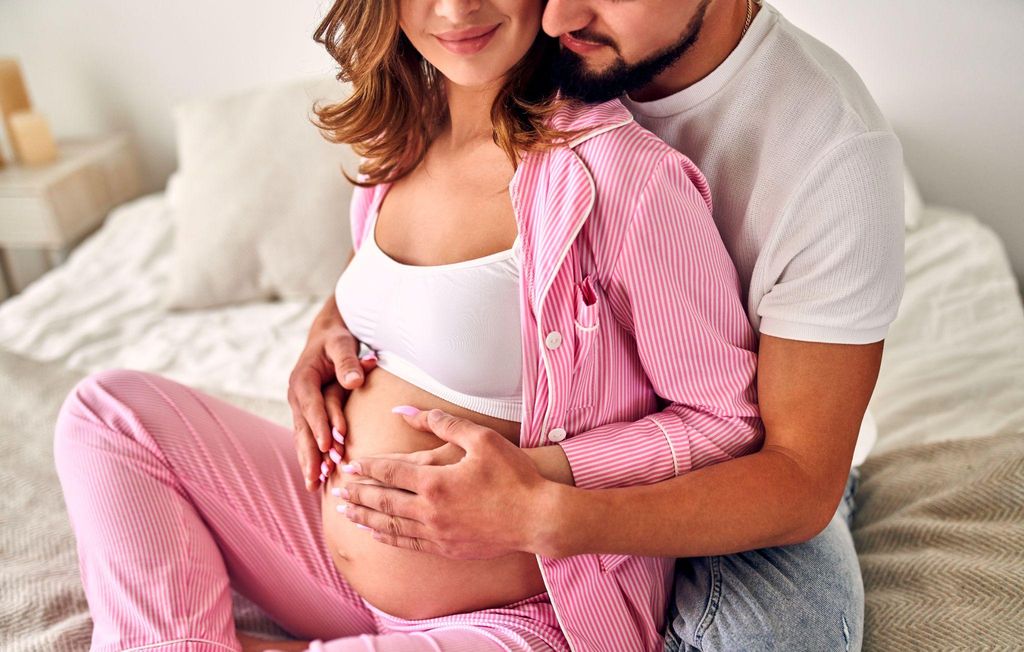 A pregnant couple sharing an intimate moment and strengthening their bond.