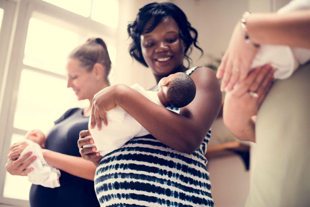 A group of expectant mothers in a C-section antenatal class learning about recovery after surgery.